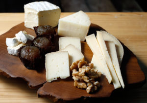 A cheese plate featuring (from left to right) Pennyroyal Farm Bollie's Mollies, Amexia D'Elvas Convento de Serra natural preserved plums, Bleating Heart Cheese Fat Bottom Girl, raw local almonds, and Point Reyes Cheese Company Gouda, aged two years, assembled by cheese monger Omar Mueller of Freestone Artisan Cheese, in Freestone, California on Tuesday, November 29, 2016. (Alvin Jornada / The Press Democrat)