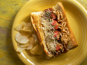 The Meatball Sub on a toasted ciabatta roll with provolone and asiago cheese, marinara and french fried onions from Canevari's Delicatessen & Catering in Santa Rosa. (John Burgess/The Press Democrat)