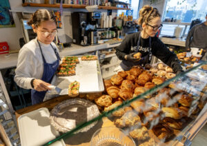 Baker Amari Quiron adds Lox Toast while pasty chef Sara Ellsworth, right, tidies up the display of goods at Quail & Condor bakery Monday, Jan. 6, 2025, in Healdsburg. (John Burgess / The Press Democrat)