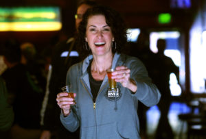 Russian River Brewing Company owner Natalie Cilurzo offers a test of Pliny the Younger to the photographer before the release in Santa Rosa on Friday. (JOHN BURGESS / The Press Democrat)