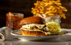 Prime Burger Royale with comté cheese, onion marmalade, truffle mayo on a brioche bun with frites from Augie’s French Tuesday, November 28, 2023, on Courthouse Square in Santa Rosa. (John Burgess/The Press Democrat)