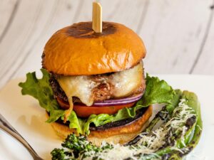 The ìRealî Hamburger (Pork) with a side of Grilled Broccolini from Vine Burgers in Santa Rosa Wednesday, January 11, 2023. (John Burgess/The Press Democrat)