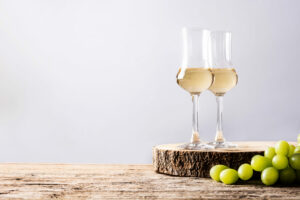 Italian golden grappa drink on wooden table. (etorres/Shutterstock)