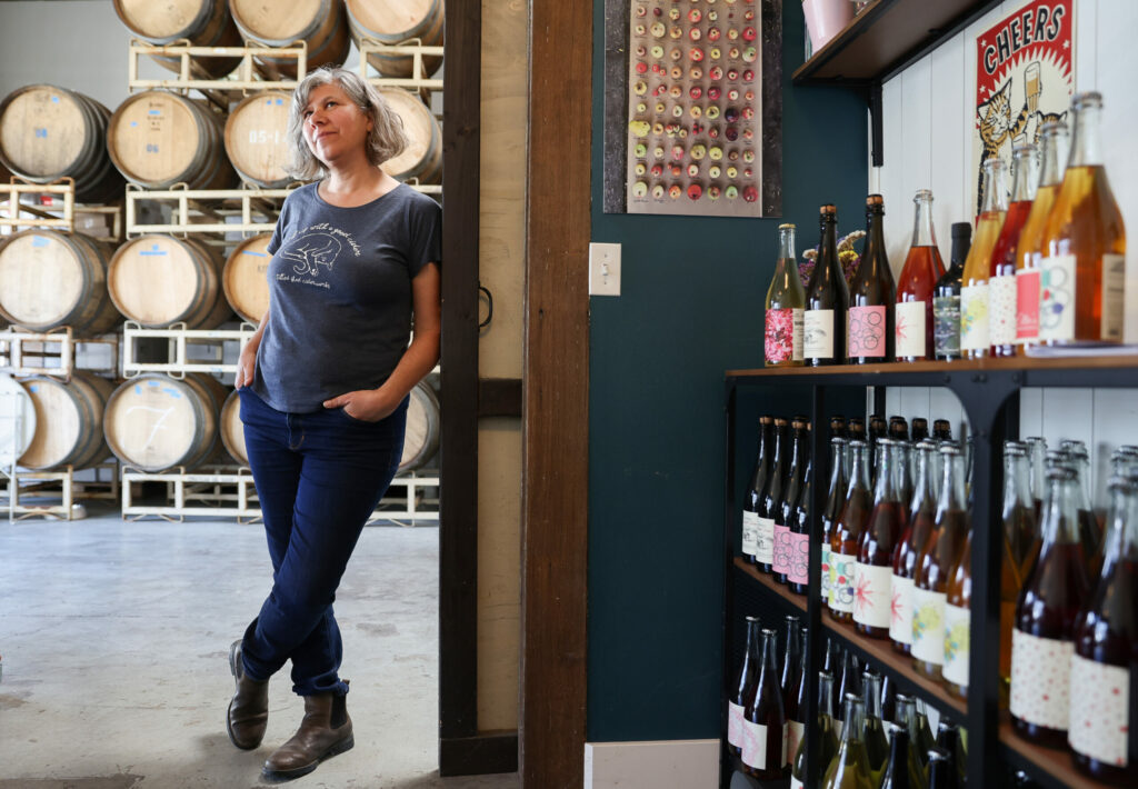 Tilted Shed Ciderworks co-owner Ellen Cavalli and her husband, Scott Heath, created Ellie's Non-Alcoholic Cider after she was told to reduce her alcohol intake when she was diagnosed with breast cancer. Photo taken at the Tilted Shed Ciderworks tasting room in Windsor on Thursday, April 20, 2023. (Christopher Chung/The Press Democrat)